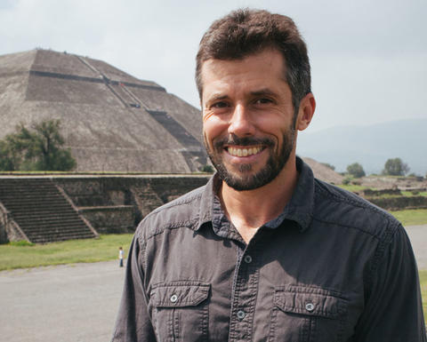 smiling david carballo in front of ancient pyramid.