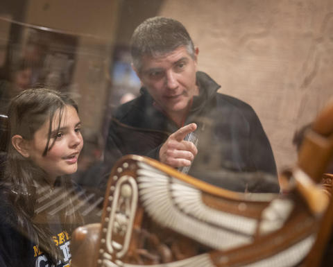 father and daughter look at tutankhamun throne.